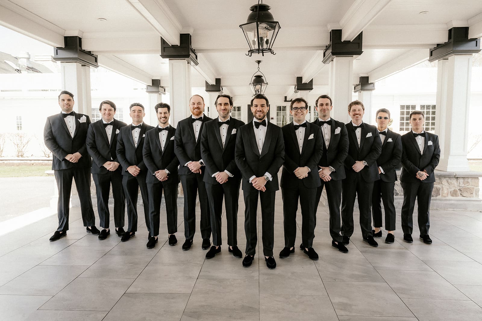 Groomsmen in black tuxedos during bridal party photos at The Ryland Inn.