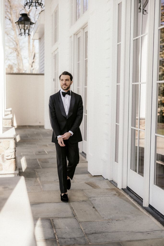 Groom walking outside of The Ryland Inn wedding venue.