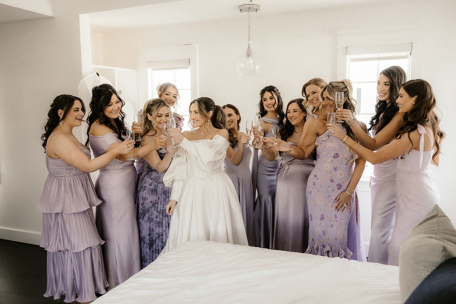 Bride and bridesmaids toasting with glasses of champagne.