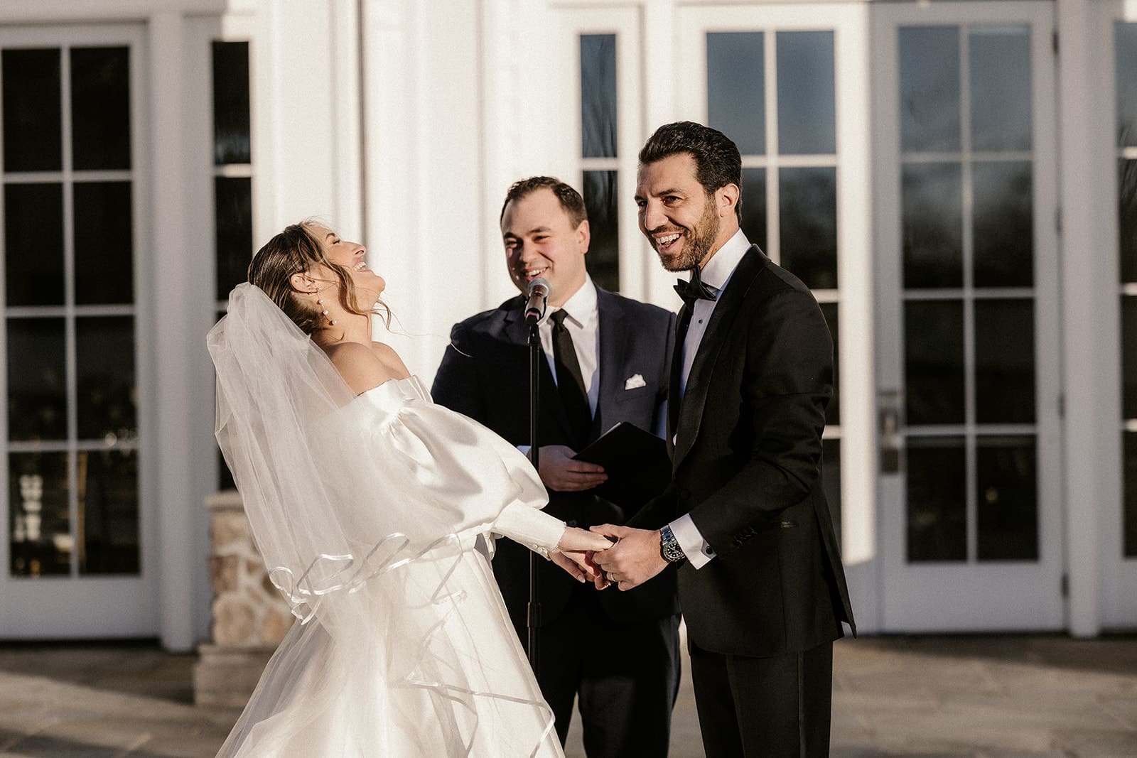 Bride and groom laughing during their ceremony at The Ryland Inn wedding venue.