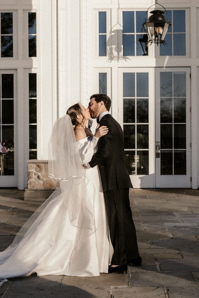 Bride and groom sharing a kiss during their The Ryland Inn wedding ceremony.