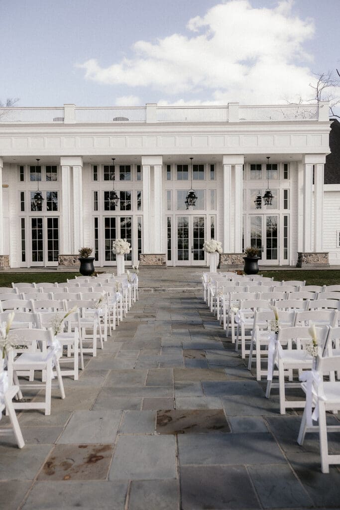 Outdoor ceremony setup with white chairs at The Ryland Inn wedding venue.
