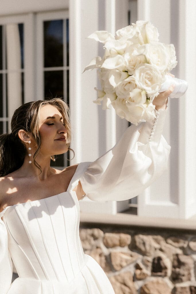 Bride holding a white bouquet during portraits at The Ryland Inn wedding venue.