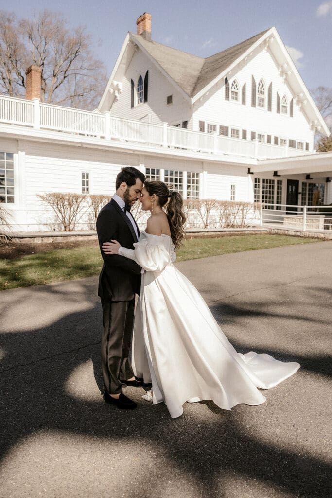 Bride and groom touching foreheads during outdoor portraits at The Ryland Inn wedding venue in White House Station, NJ.