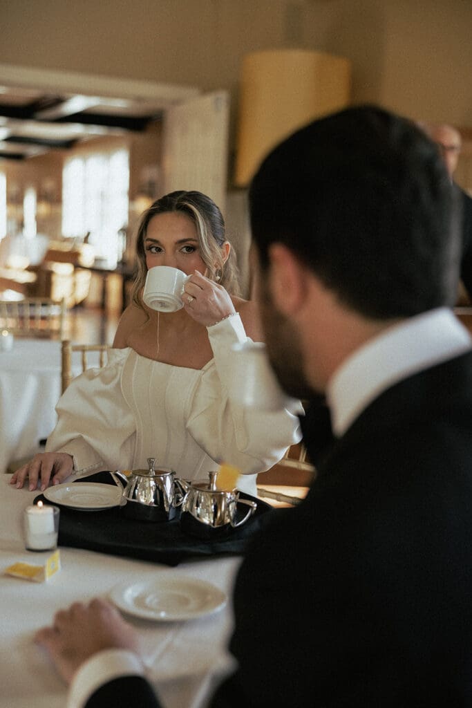 Bride drinking tea with the groom before their The Ryland Inn wedding ceremony.