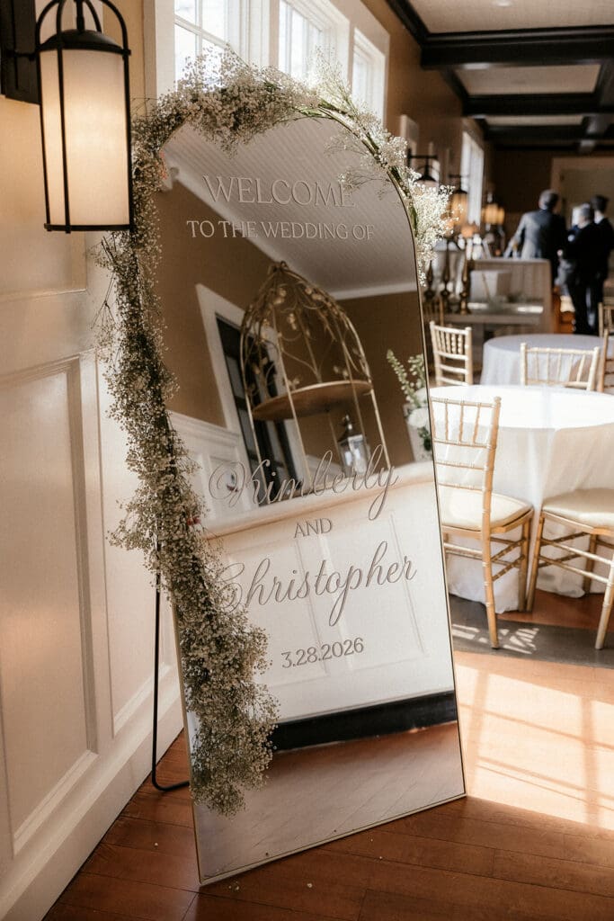 Wedding reception mirror with couples name and wedding date.