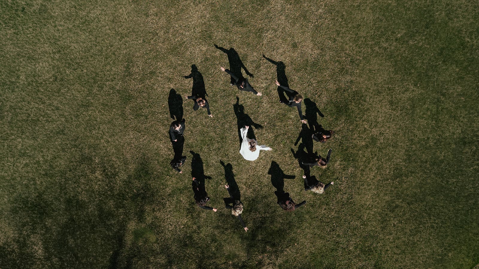 Overhead drone shot of bridesmaids running around the bride in a circle during her getting ready moments at The Ryland Inn wedding venue.