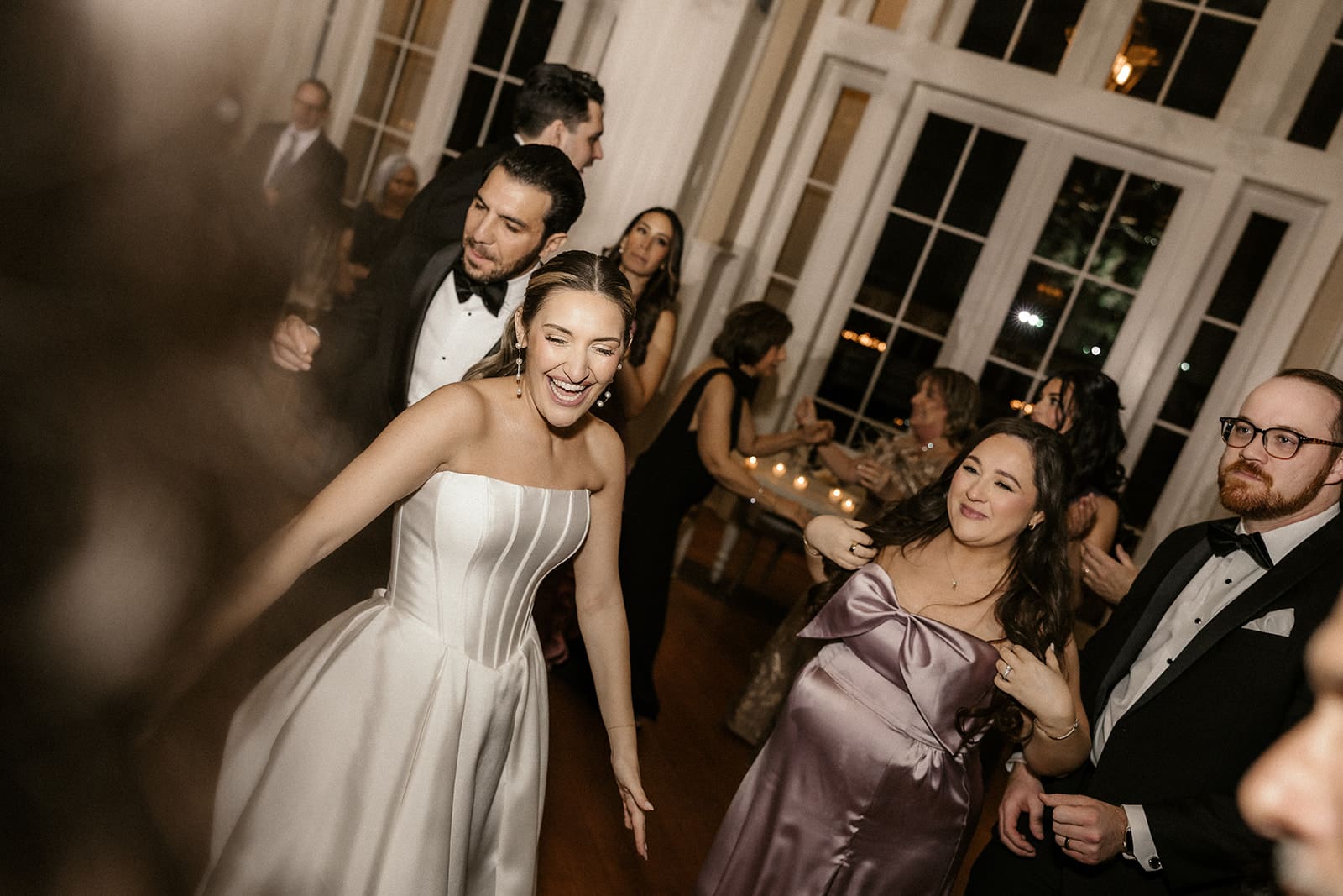 Bride and groom dancing on the dance floor with guests.