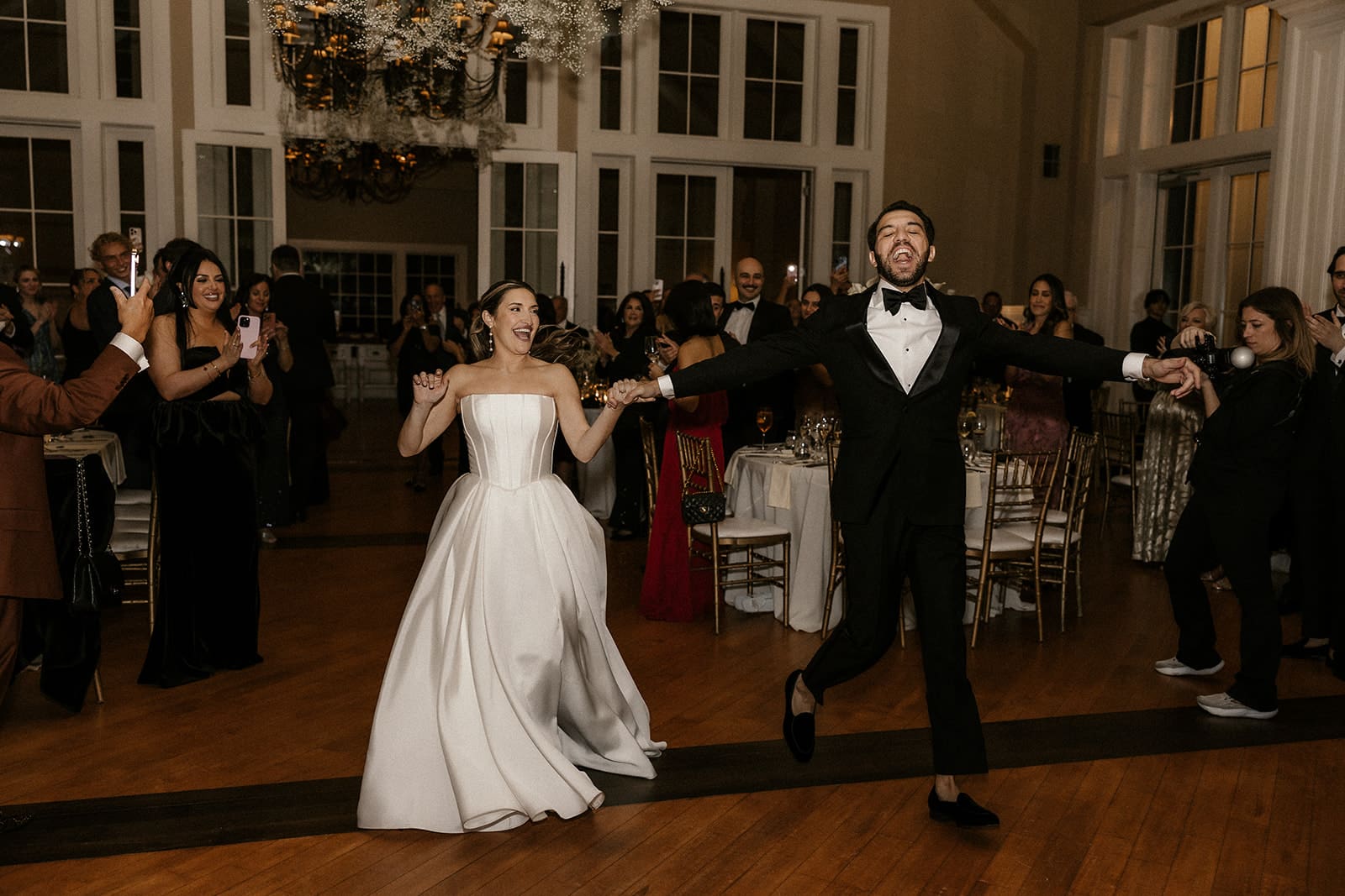 Bride and groom making their reception entrance in the Grand Ballroom at The Ryland Inn.