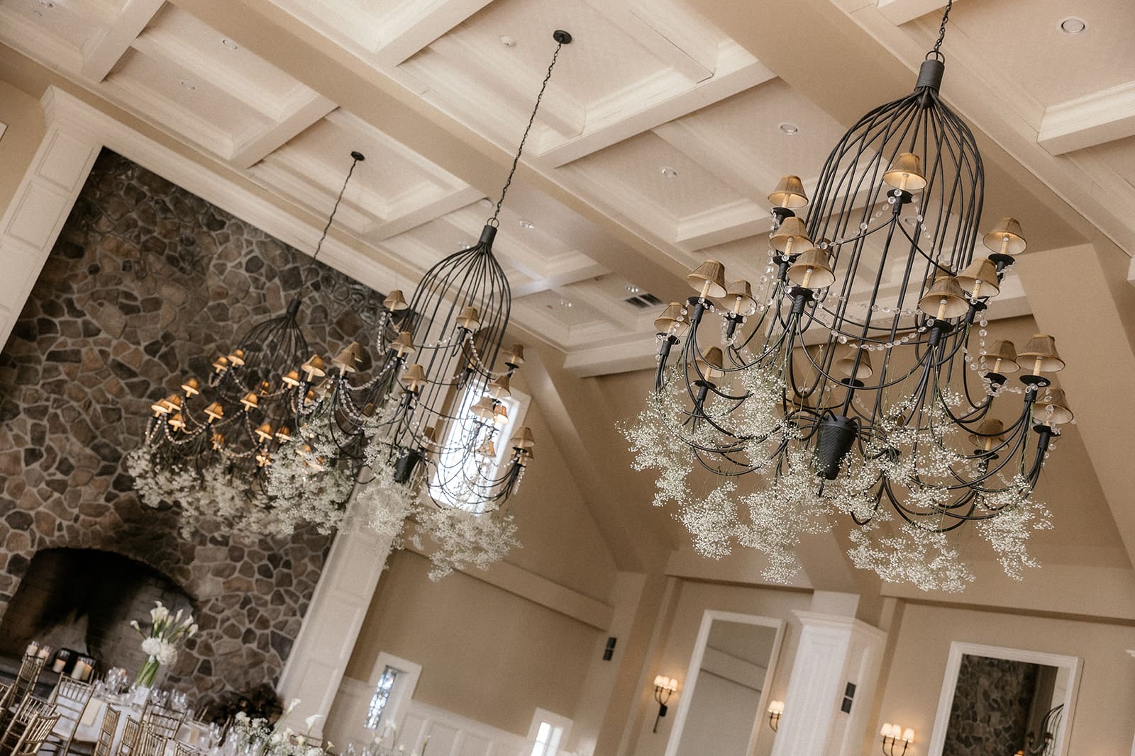 Grand Ballroom reception decor with chandeliers and white florals at The Ryland Inn wedding.