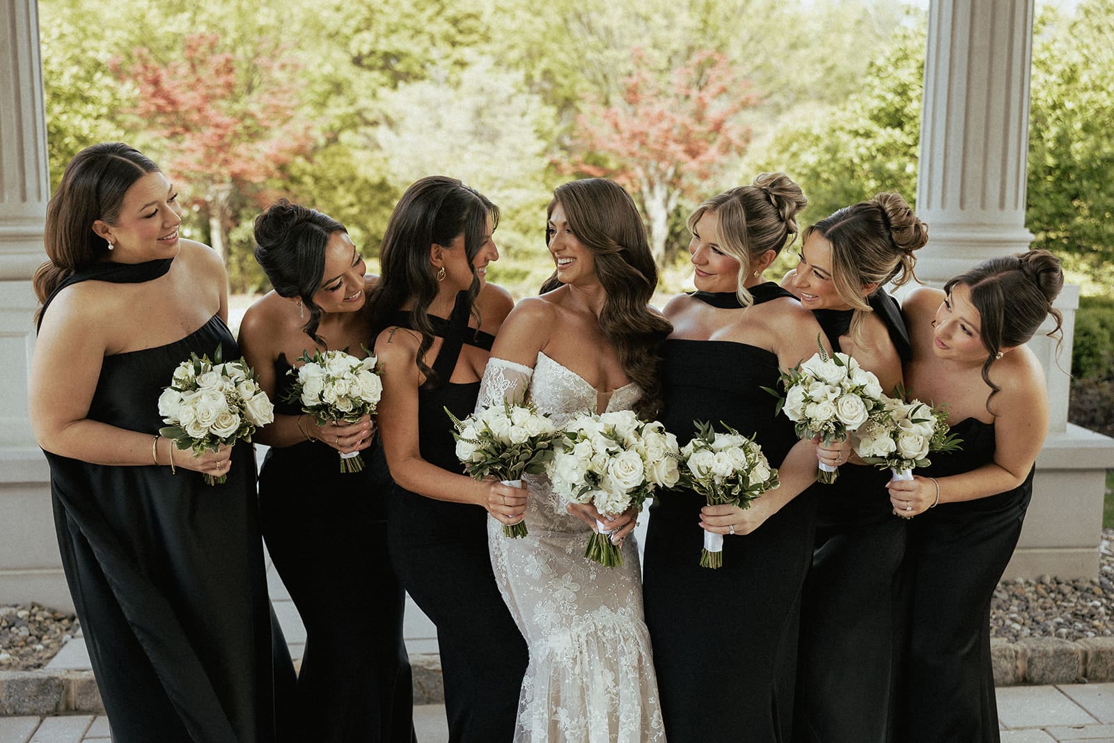 Wide shot of a bride and bridesmaids posing for portraits.