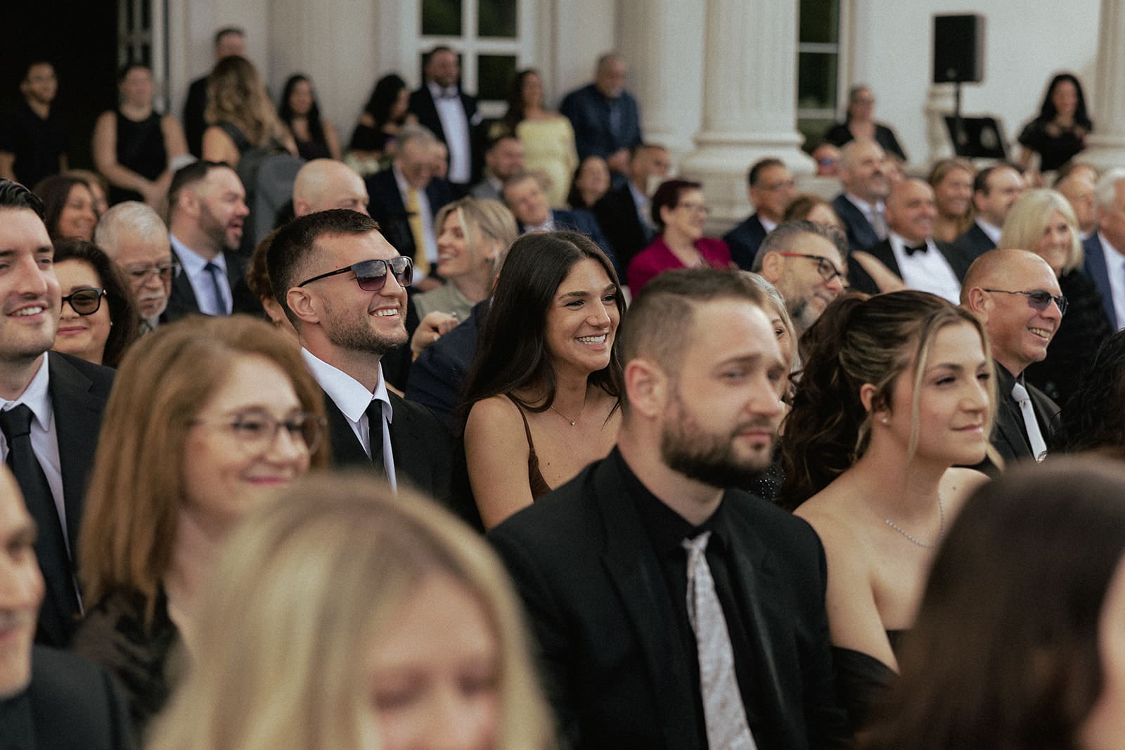 Guests watching an outdoor ceremony.