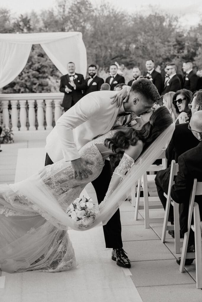 Black and white end of aisle dip kiss.