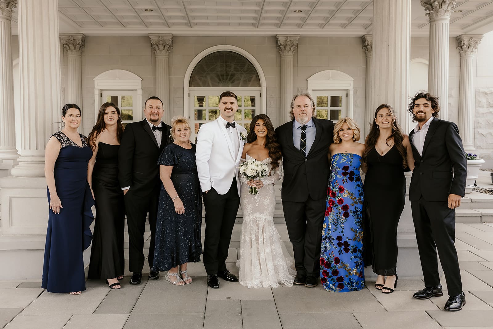 Bride and groom posing with family.