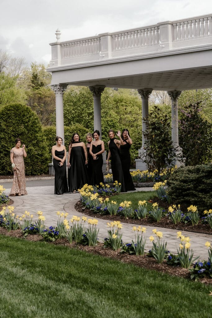 Mother of the bride and bridesmaids watching the first look unfold from afar.