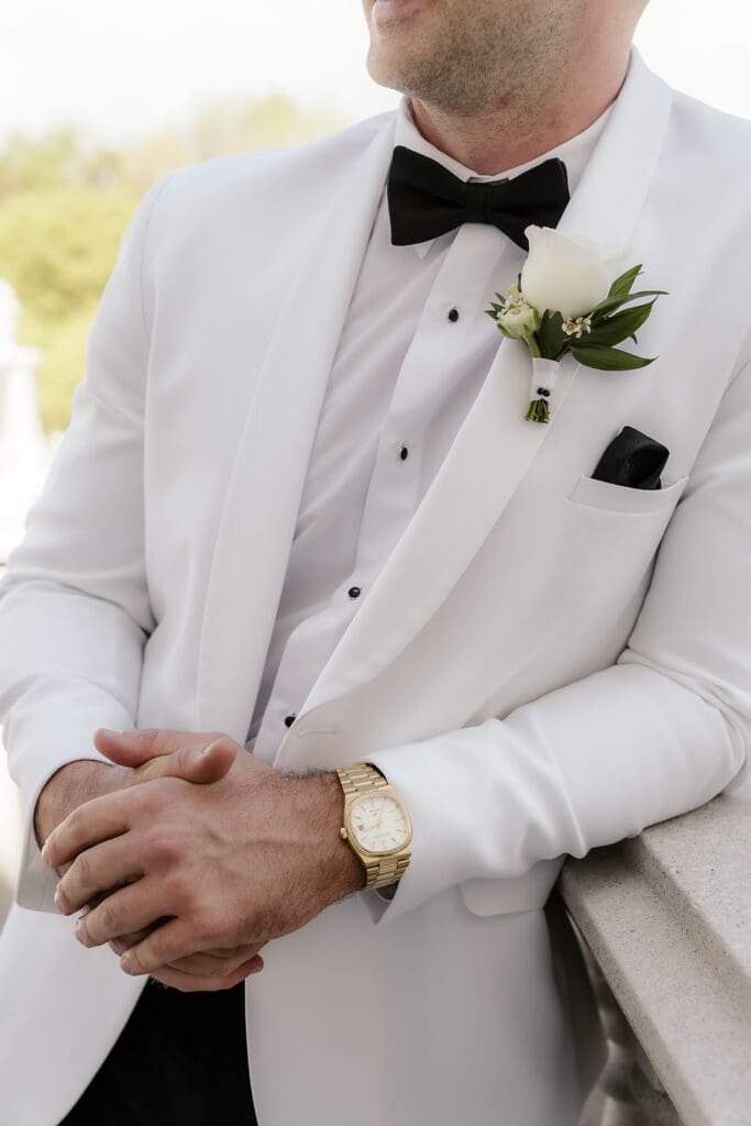 Close up shot of the groom in a white tux.