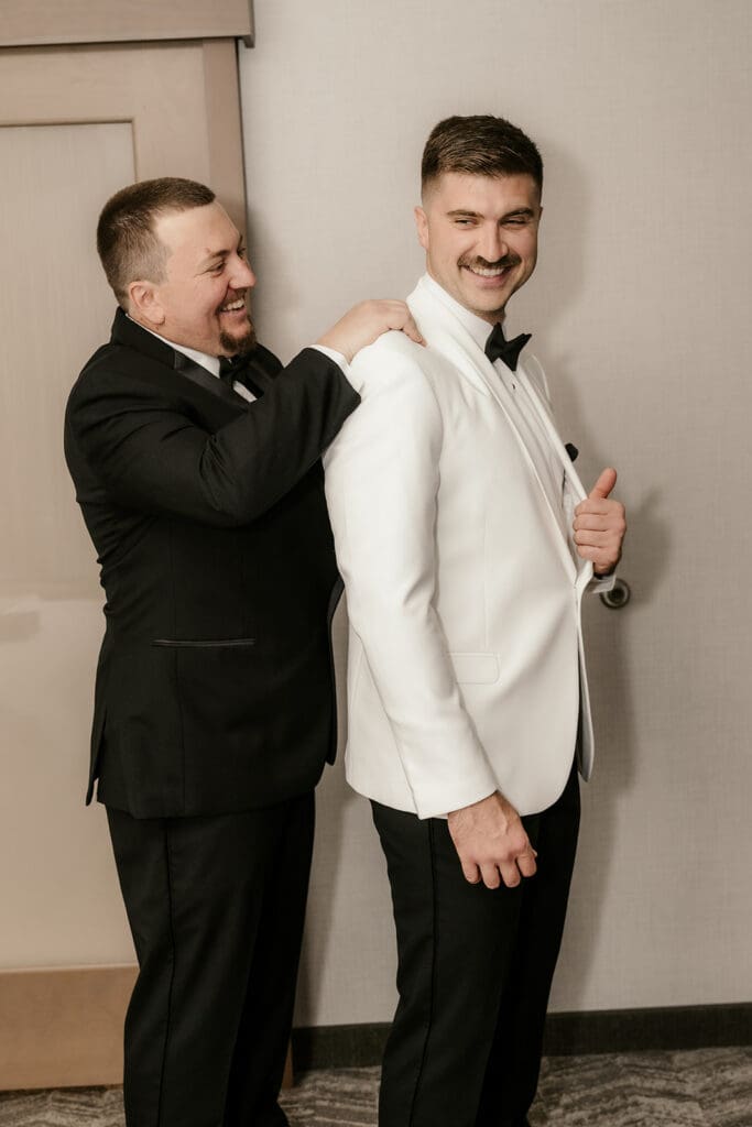 Groomsmen helping the groom get ready at The Palace at Somerset Park.