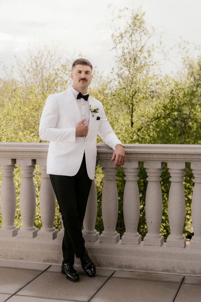 Outdoor grooms portraits on the balcony at The Palace at Somerset Park.