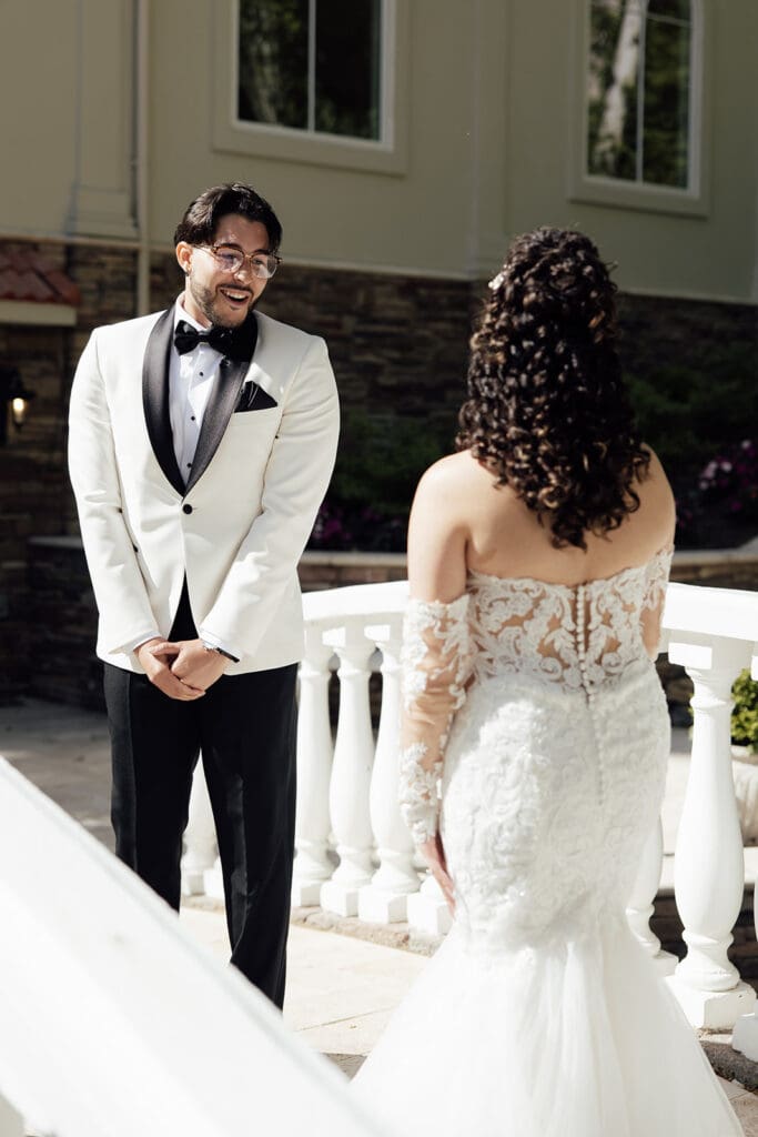 Groom turning around to see his bride during their first look on the bride at Nanina's in the Park.
