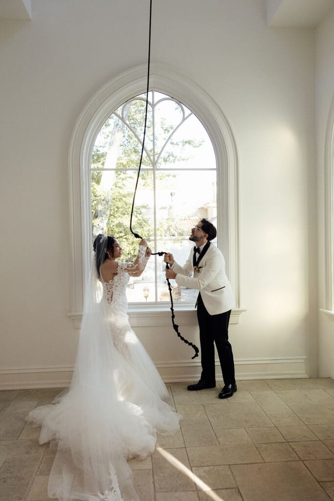 Bride and groom ringing the bell after their Nanina's in the Park wedding ceremony in The Chapel.