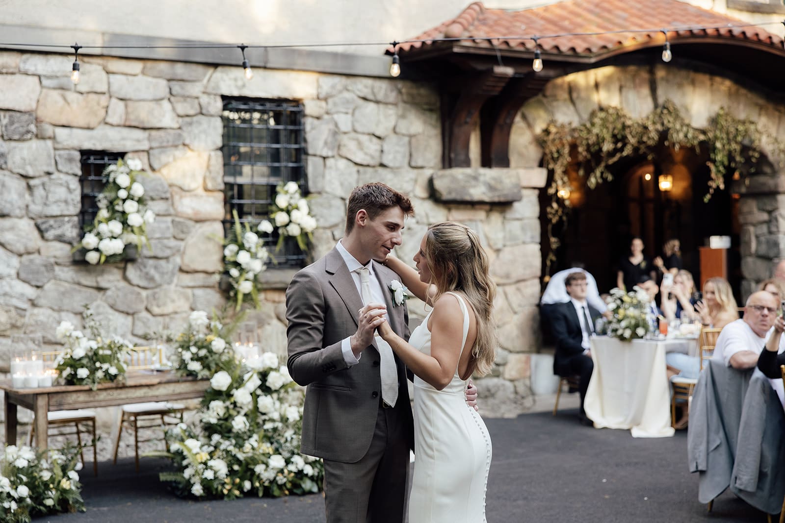 Bride and groom dancing during their Arrow Park wedding reception in The Mansion Courtyard.