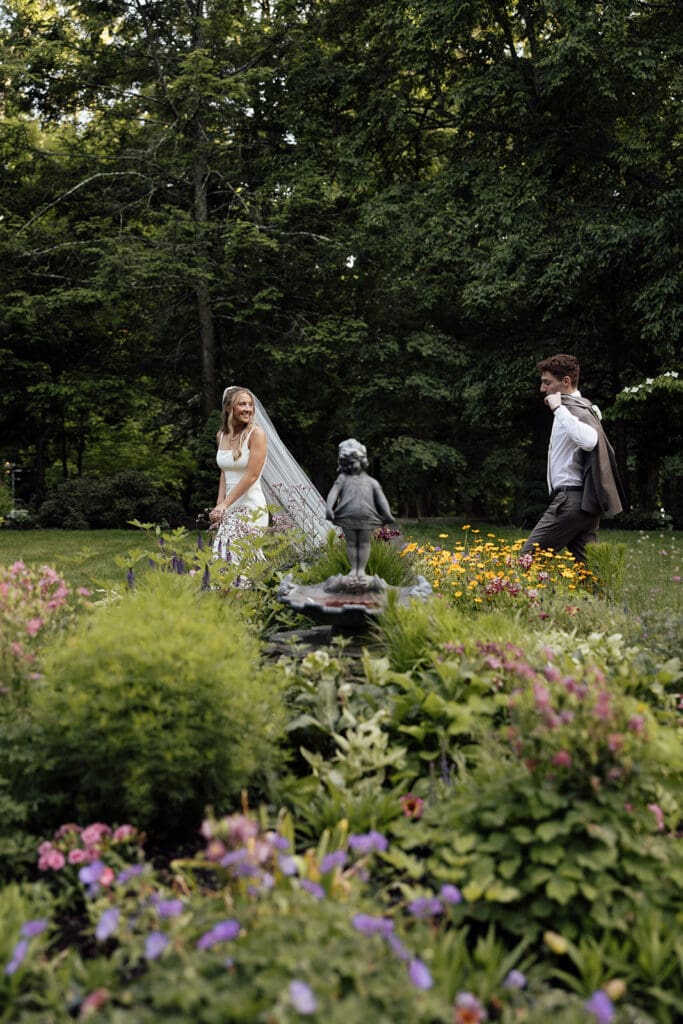 Bride and groom walking in the Ceremonial Garden at Arrow Park wedding venue.