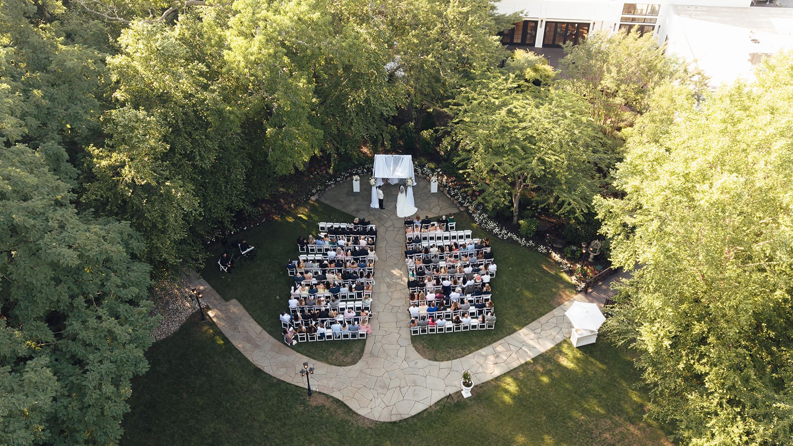 Overhead drone shot from a outdoor garden wedding ceremony at The English Manor in Ocean, New Jersey. 