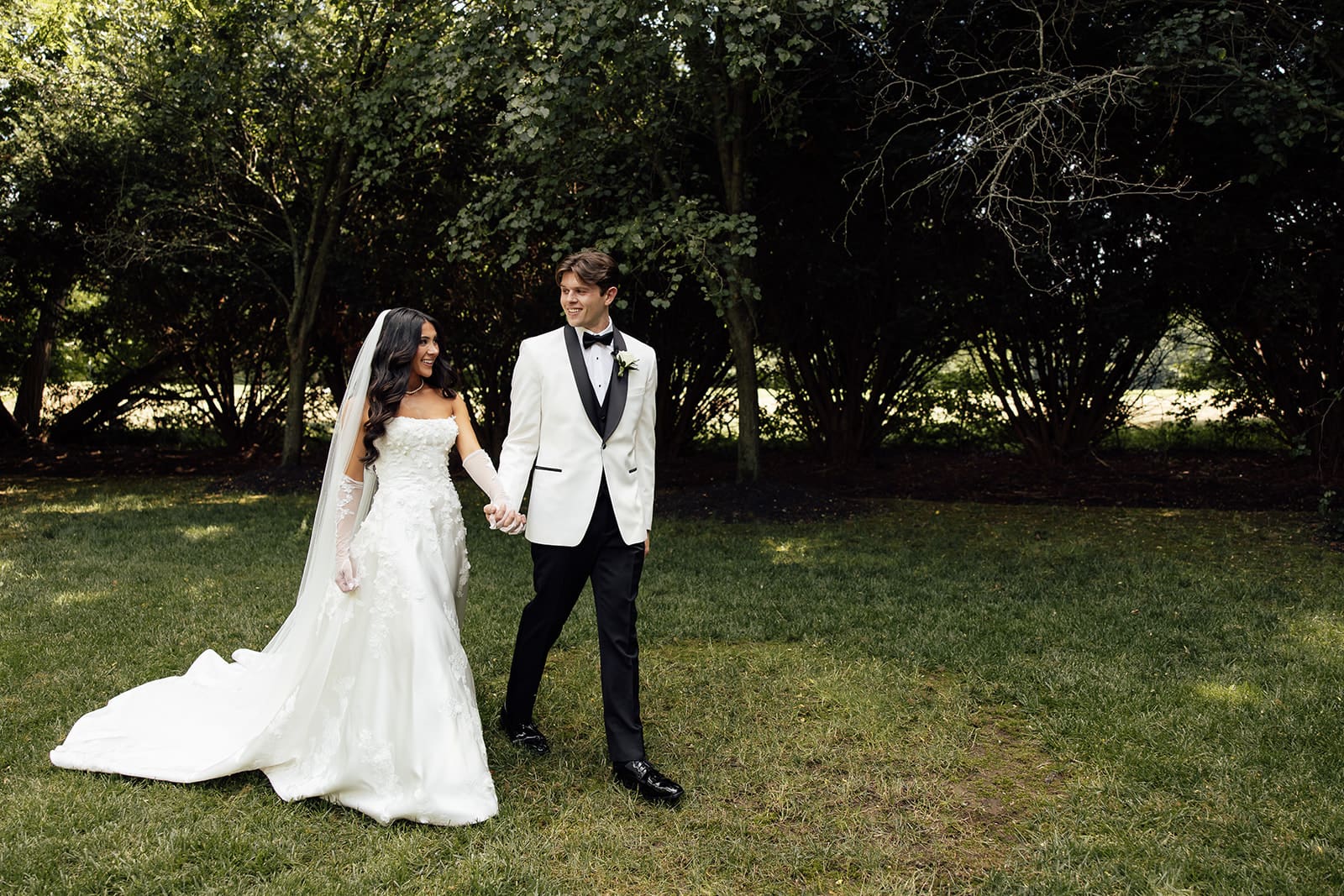 Bride and groom walking outdoors. 