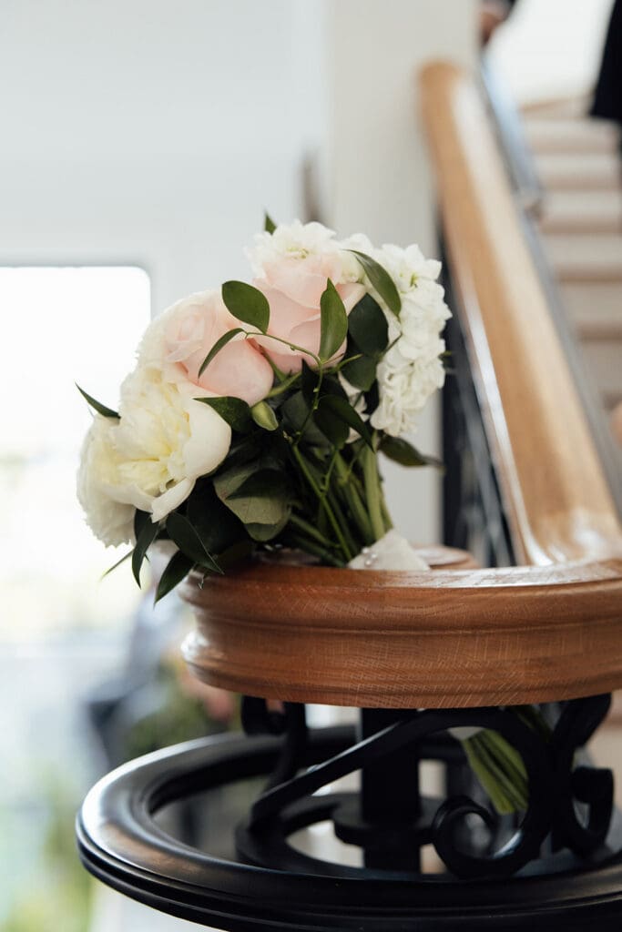 Brides bouquet resting on the venues railing. 