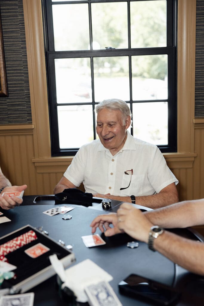 Guys playing poker in the grooms suite at The English Manor in Ocean, New Jersey. 