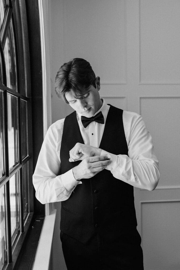 Black and white portrait of the groom getting ready for his wedding at The English Manor. 